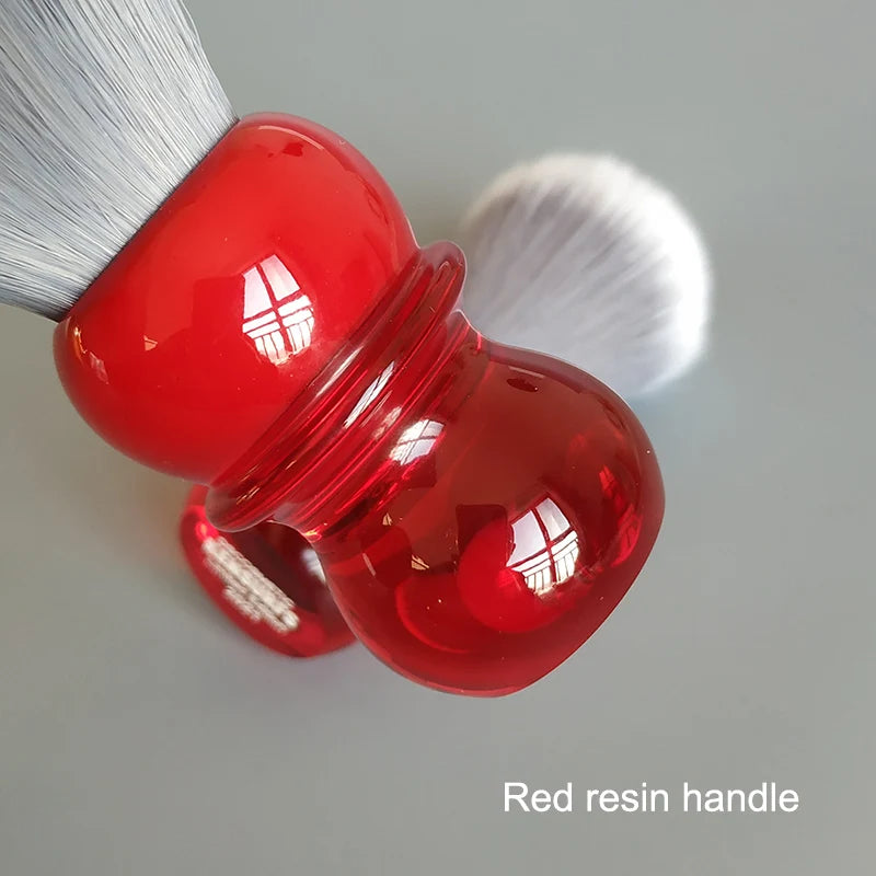 Shaving brush with soft bristles and a red resin handle