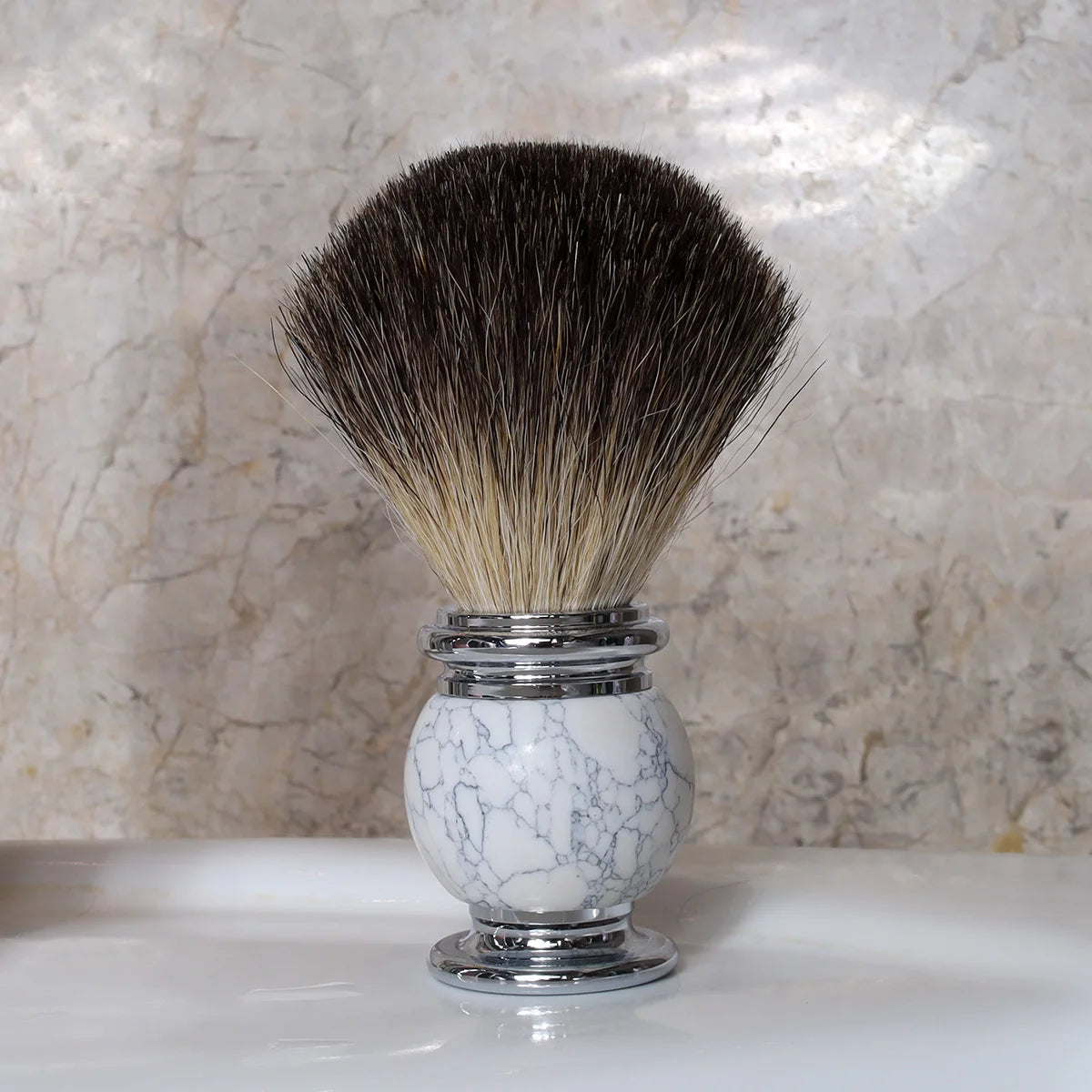 Silver tipped badger shaving brush with white marble handle and chrome finishes